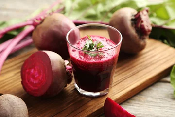 Photo sur Aluminium Jus Fresh beets juice in glass on a grey wooden table