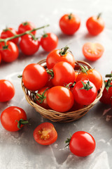 Cherry tomatoes branch on a grey background
