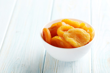 Dried apricots on blue wooden table