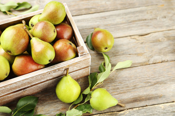 Ripe pears on grey wooden table