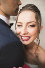 Portrait of happy newly wedding couple with bouquet