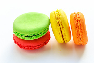 pile of colorful and tasty french macaroons on white background
