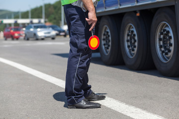 Policeman controlling traffic on the highway