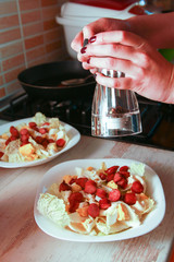 Happy housewife cooking squid with seafood in home kitchen