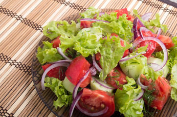Fragment of vegetarian salad from fresh vegetables closeup