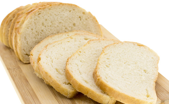 cutting wheat bread on a white background