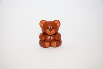 Plasticine chocolate happy bear with gift holiday boxes on a white background
