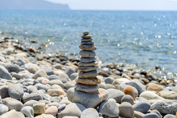 Fototapeta na wymiar Balanced stones on the beach of Paleochora town on Crete island
