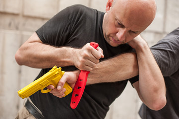 Kapap instructor demonstrates self defense techniques against a gun point. Gun Disarm.