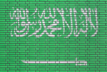 Saudi Arabian flag painted on brick wall