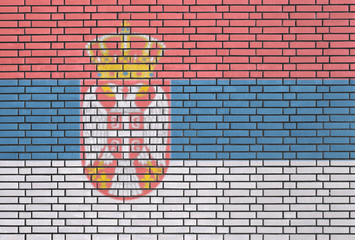 Serbian flag painted on brick wall
