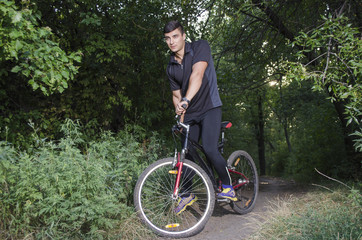 Fototapeta na wymiar the guy rides a bike