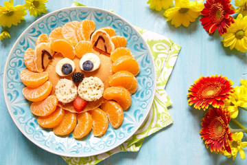 Funny pancake lion with mandarins