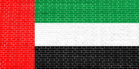 Flag of the United Arab Emirates on brick wall texture background