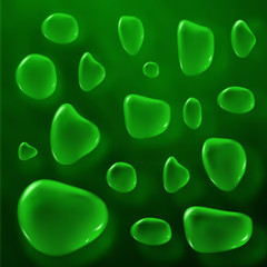 Transparent green color drops on black background.