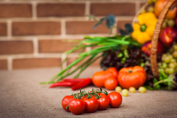 cherry tomatoes on the branch, On background Composition with assorted raw organic vegetables. Horizontal.