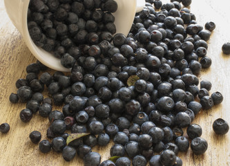blueberries scattered out of the white circles on the wooden surface