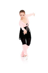 Young beautiful dancer posing on isolated white studio background. Pretty woman - modern style dancer or ballerina in ballet pose.