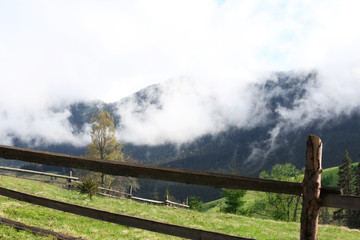 Wooden fence on mountain forest background