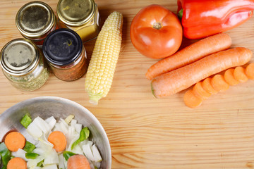Vegetables and seasonings on wooden table.