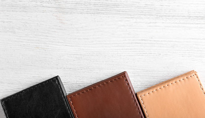Leather wallets on wooden background