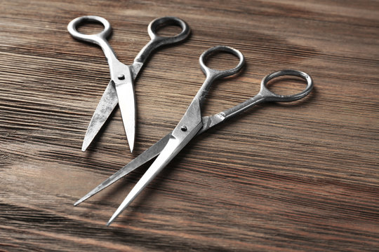 Vintage scissors on wooden background
