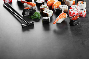 Sushi set and chopsticks on dark background