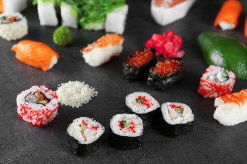 Sushi set and ingredients on dark background