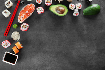 Obraz na płótnie Canvas Sushi set and ingredients on dark background