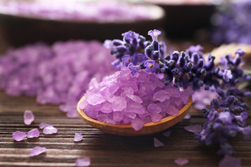 Purple sea salt with lavender on wooden background