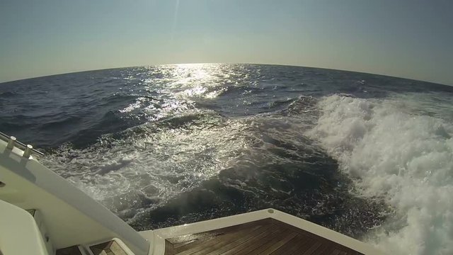 high-speed motor yacht floats on the sea, foamy trace on water from motor yacht, A shot of a large wake behind a boat,