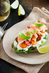 Sandwich with soft cheese, salmon and tomatoes