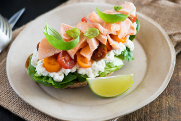 Sandwich with soft cheese, salmon and tomatoes