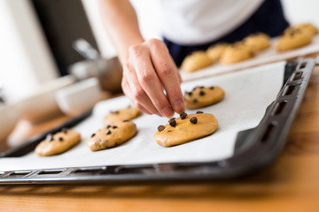 Adding chocolate on cookies with metal tray