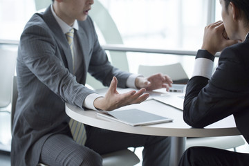 Two young businessmen have a meeting