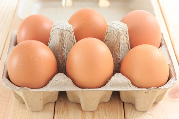 Egg in carton pack on wooden table, Chicken Egg
