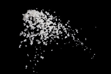 Salt flying in the air isolated on black background , stop motio