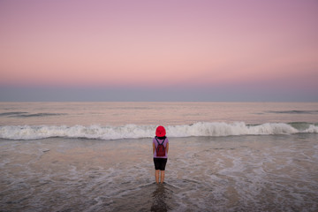 Lone woman facing the sea