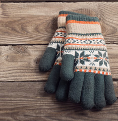 winter gloves on wooden background