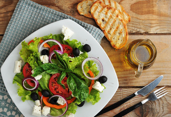 salad with feta cheese, olives, tomatoes and lettuce and Basil o