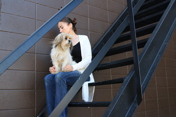 Girl Sitting Alone on the Stairs With Her Dog