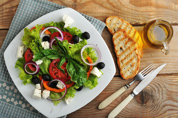 salad with feta cheese, olives, tomatoes and lettuce and Basil o