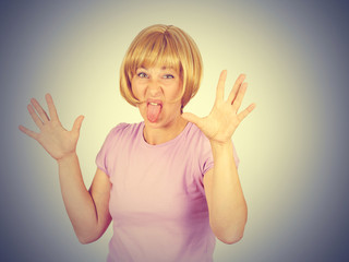 Young pretty woman with funny face mocking