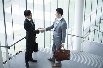 Two businessmen are shaking hands