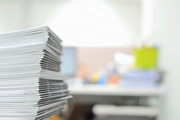 Stack of business reports on desk with copy space for text at right side,high key tone.