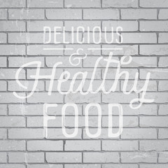 Hand drawn lettering slogan on brick wall background