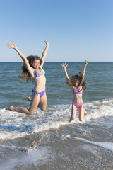 Happy children in the summer on the beach.