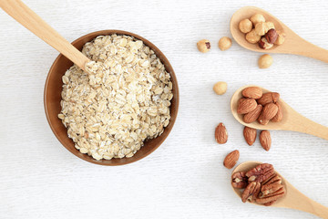 Assortment of beans and lentils in wooden spoon on wooden backgr