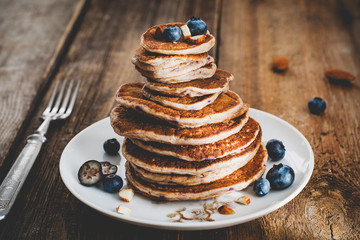 Oat blueberry pancakes stack on a plate, close up