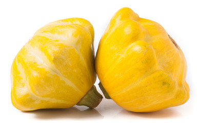 two yellow pattypan squash isolated on white background